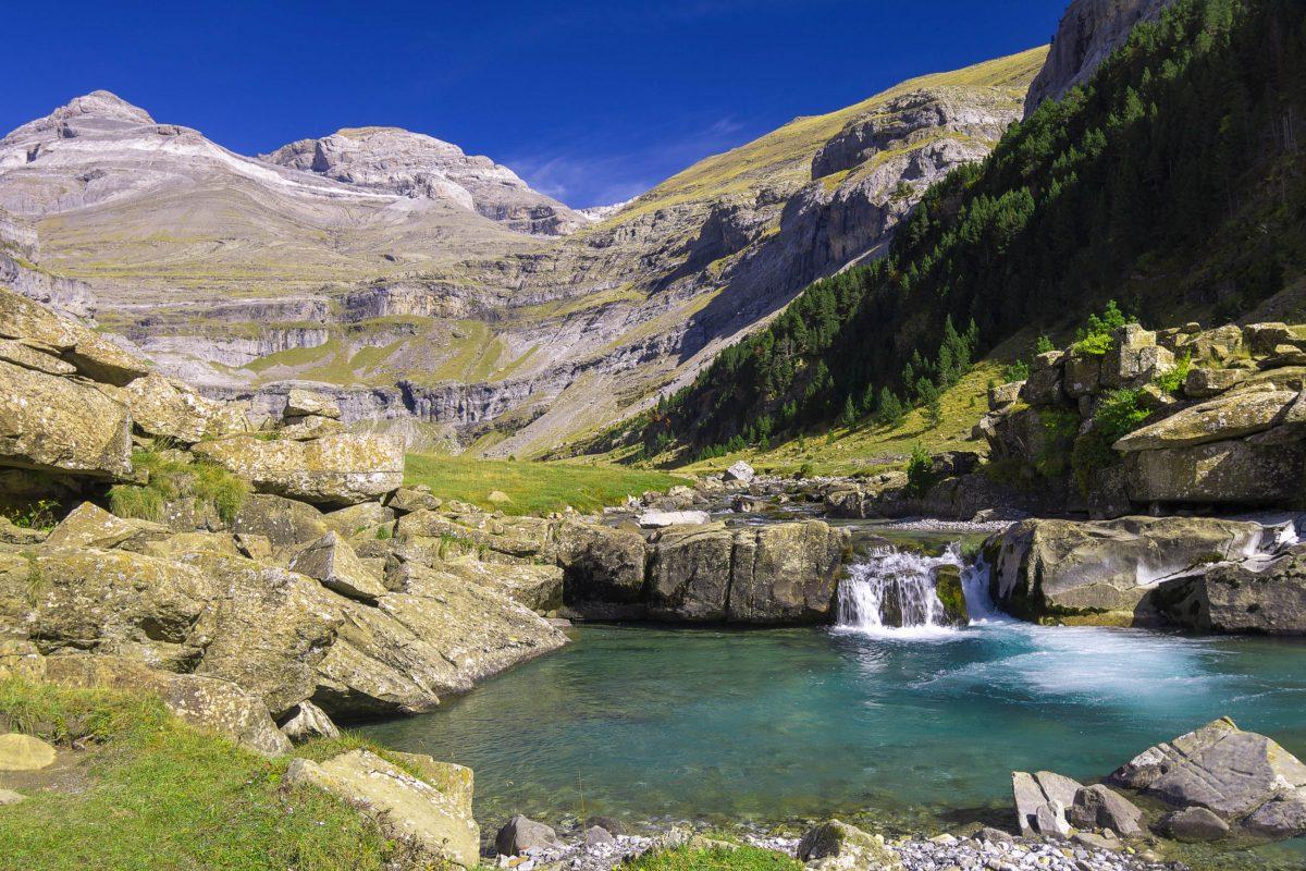 View of a waterfall and the summit of Monte Perdido in Ordesa National Park, Spain - © pedrosala / Shutterstock